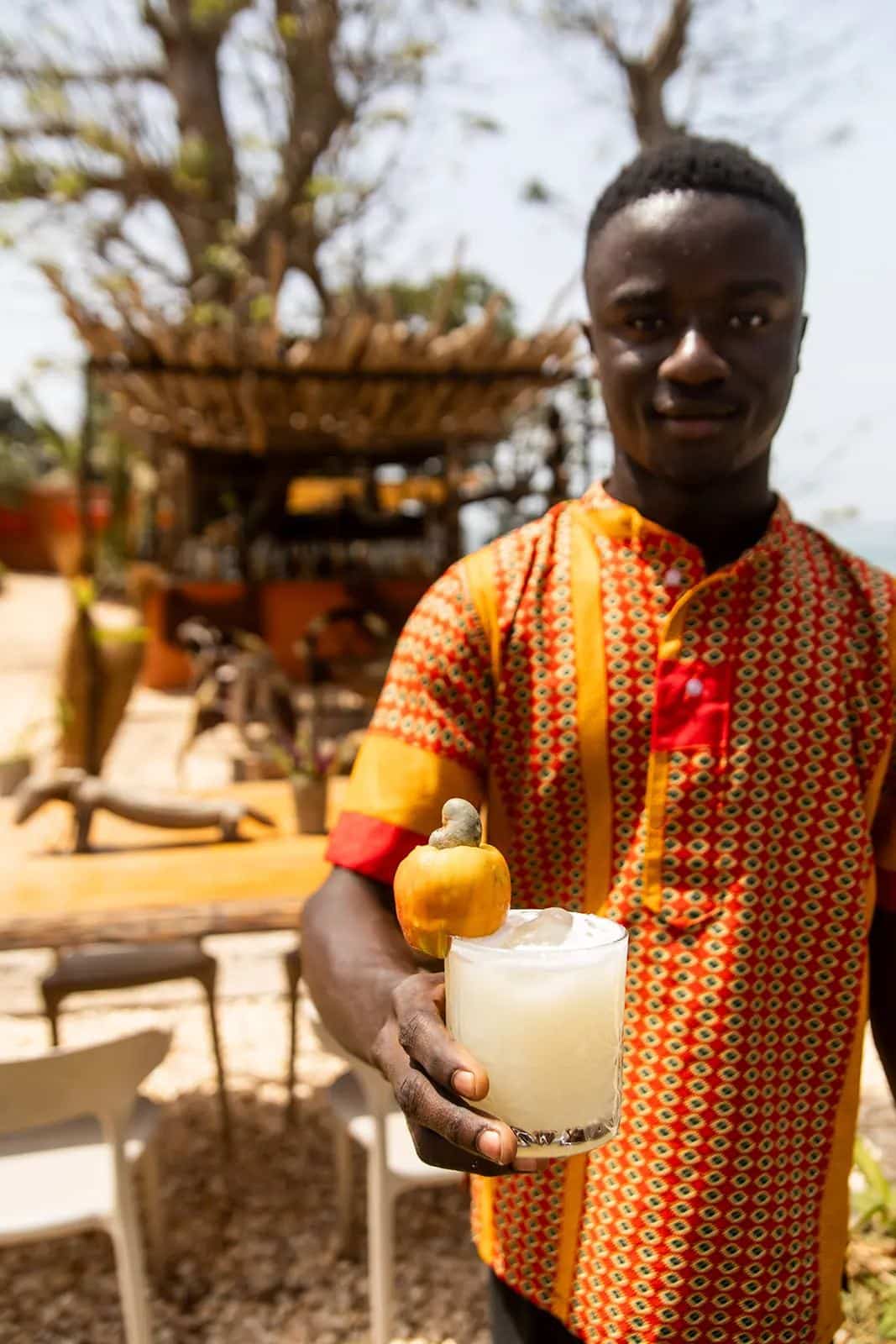 A team member presenting a drink prepared at the lodge